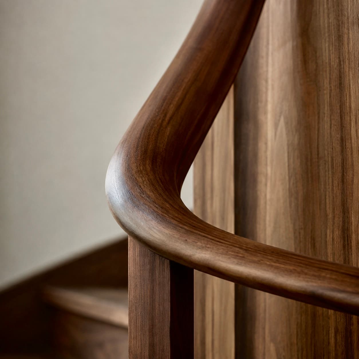 Walnut — a curved, hand-shaped walnut stair rail